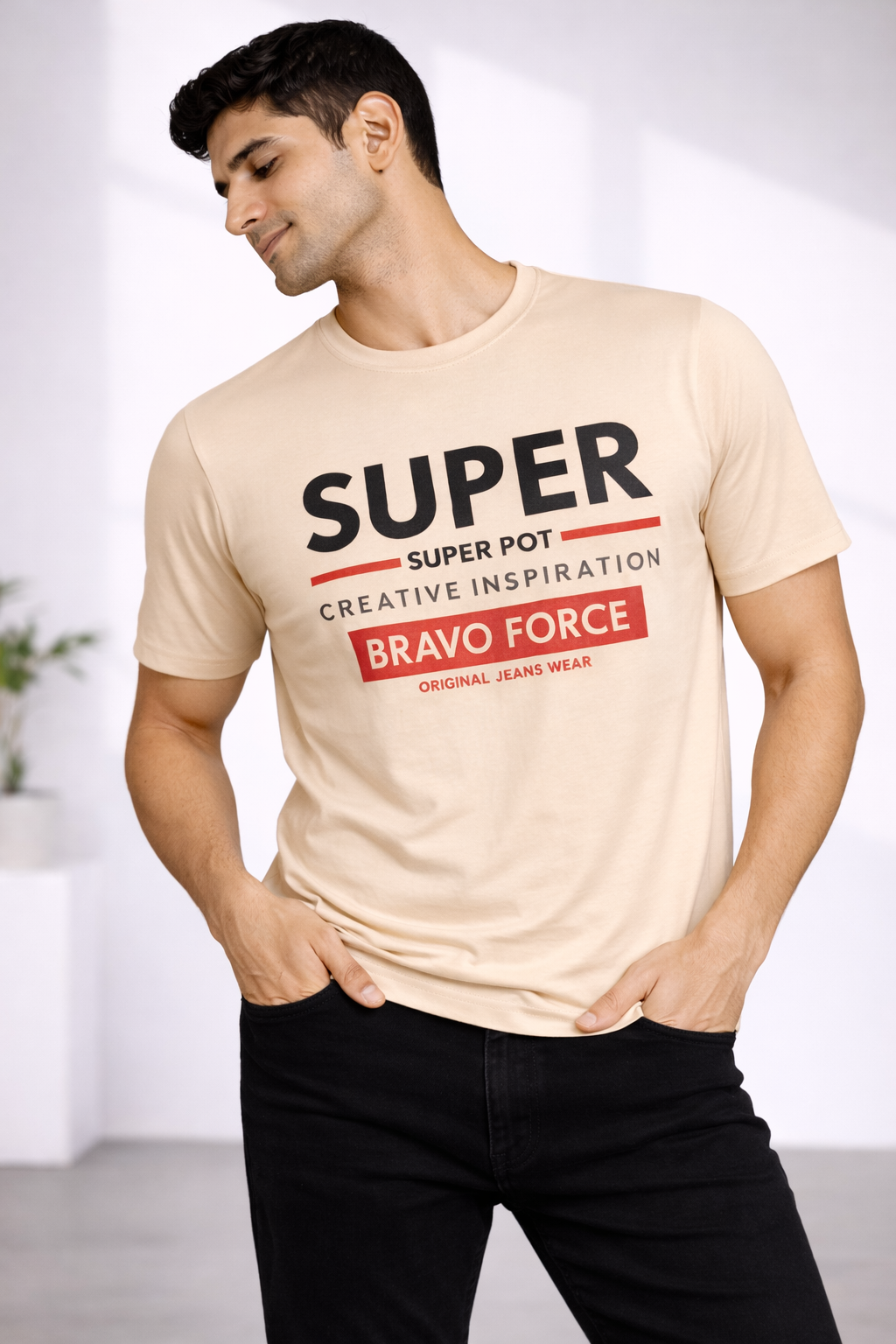 Beige Super Bravo Force graphic T-shirt with red banner print, styled with black jeans